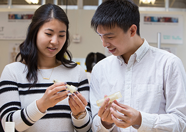 Two EIH students with their prototype device